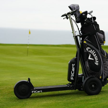 Ride-on golf scooter next to a green